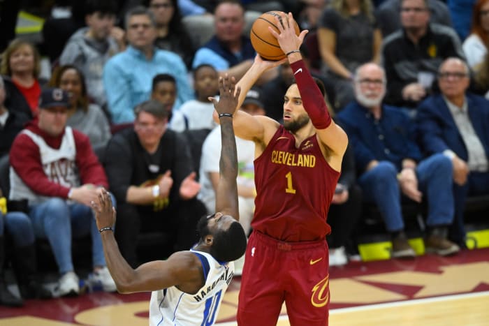 Feb 27, 2024; Cleveland, Ohio, USA; Cleveland Cavaliers guard Max Strus (1) makes a three-point basket beside Dallas Mavericks forward Tim Hardaway Jr. (10) in the fourth quarter at Rocket Mortgage FieldHouse. Mandatory Credit: David Richard-USA TODAY Sports